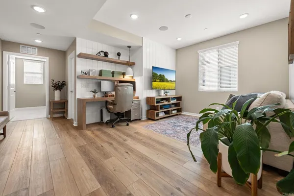 a workspace with furniture and a wooden floor