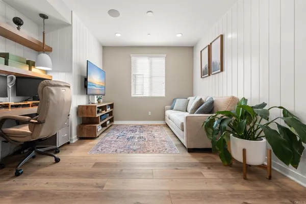 a living room with furniture rug and a window