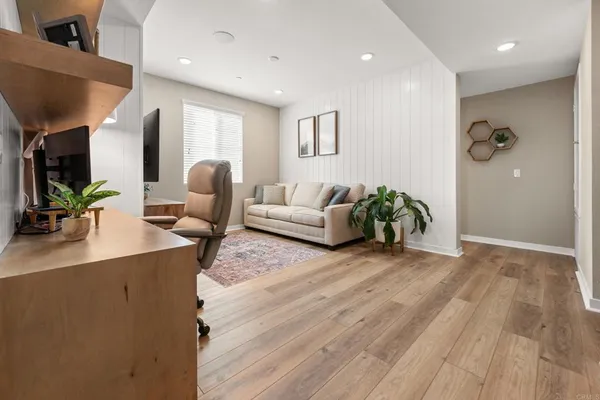 a living room with furniture and wooden floor