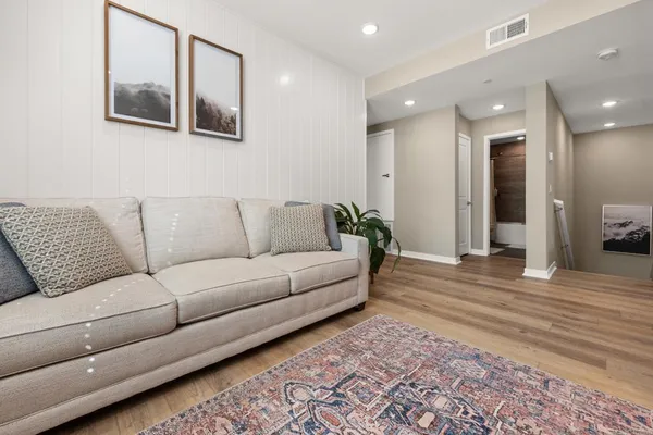 a living room with furniture and a rug