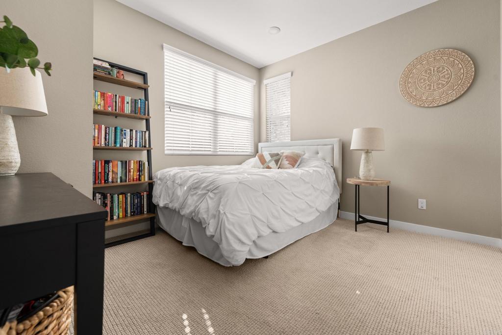 13085 Olympus Circle, Unit 1 Poway, CA 92064 - Photo 35 of 44 a bedroom with a bed bookshelf and a window