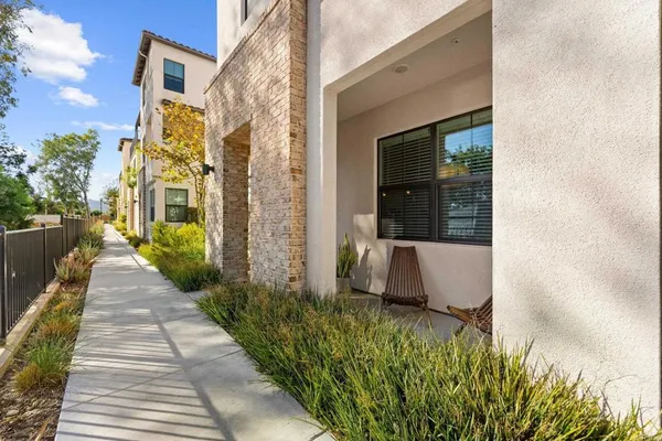 a view of a pathway both side of the house