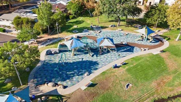 an aerial view of residential houses with outdoor space
