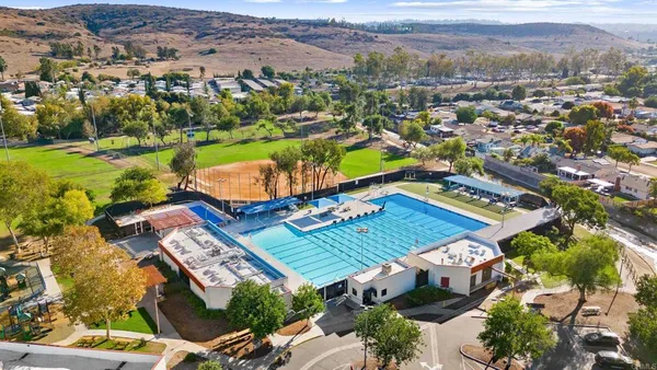 an aerial view of residential houses with outdoor space and river