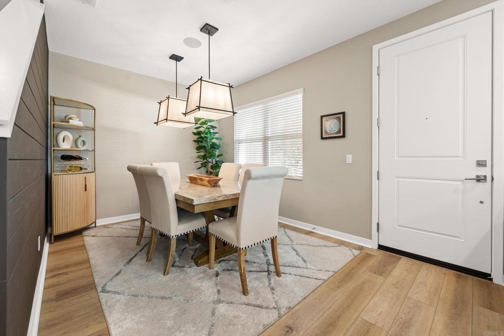 13085 Olympus Circle, Unit 1 Poway, CA 92064 - Photo 5 of 44 a dining room with furniture a chandelier and wooden floor