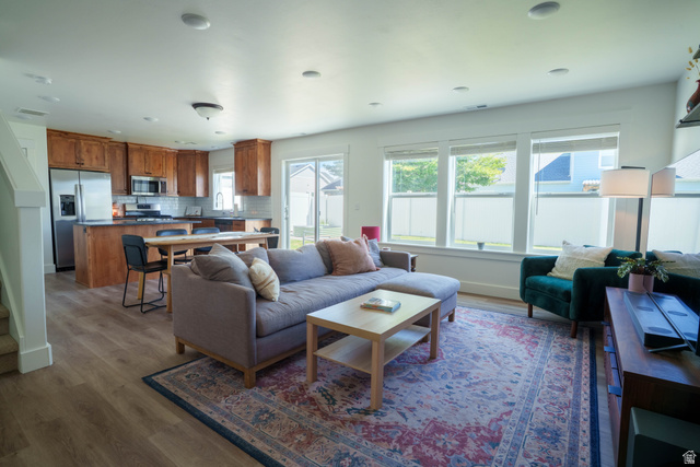1486 West 2055th Street South Logan, UT 84339 - Photo 5 of 45 Open-concept living space featuring wood-finish flooring, recessed lighting, and ample natural light from multiple windows