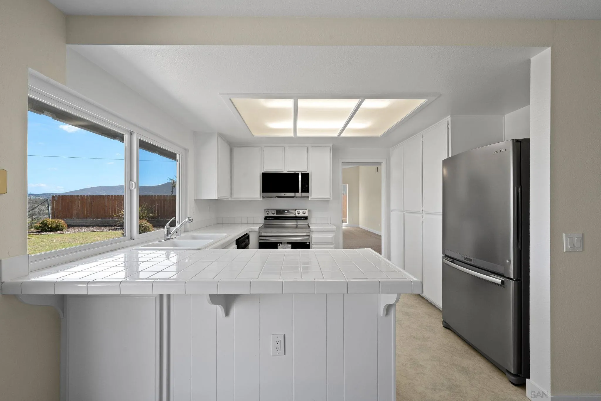 11004 Del Rio Road Spring Valley, CA 91978 - Photo 19 of 51 a kitchen with stainless steel appliances a refrigerator and a sink
