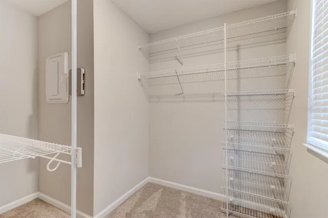a view of walk in closet with empty racks