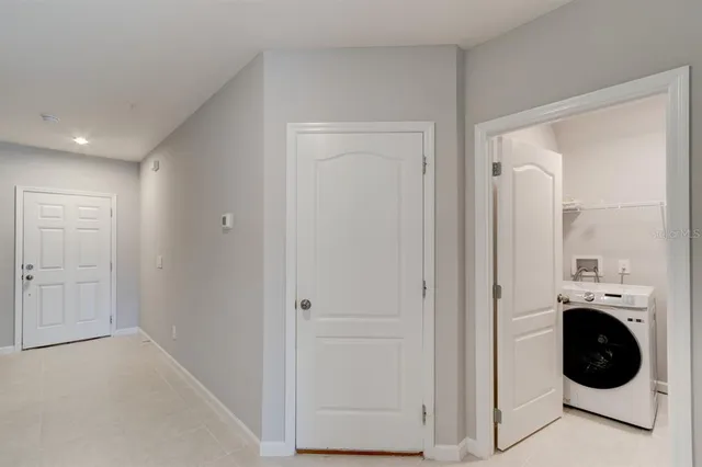 a view of a hallway with washer and dryer