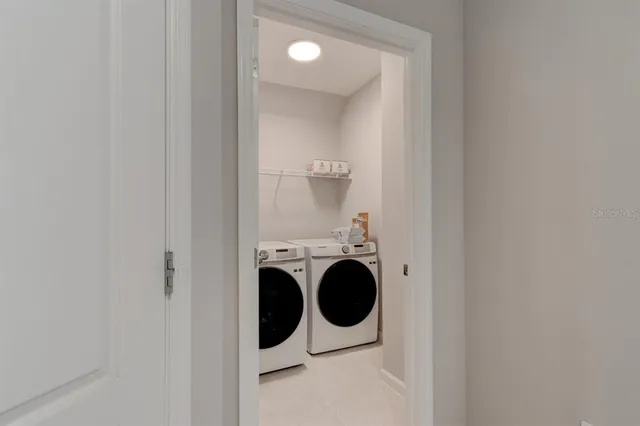 a view of a hallway with washer and dryer