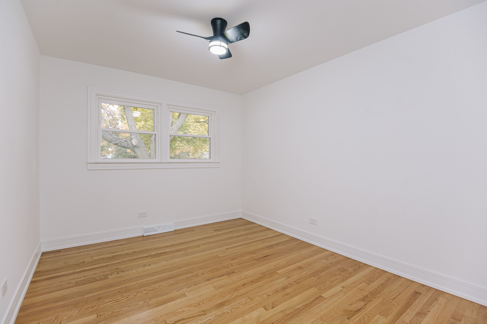 6800 97th Street Oak Lawn, IL 60453 - Photo 12 of 18 wooden floor in an empty room with a window