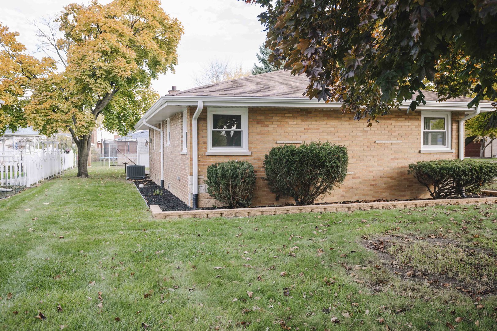 6800 97th Street Oak Lawn, IL 60453 - Photo 17 of 18 a front view of a house with a yard and garage