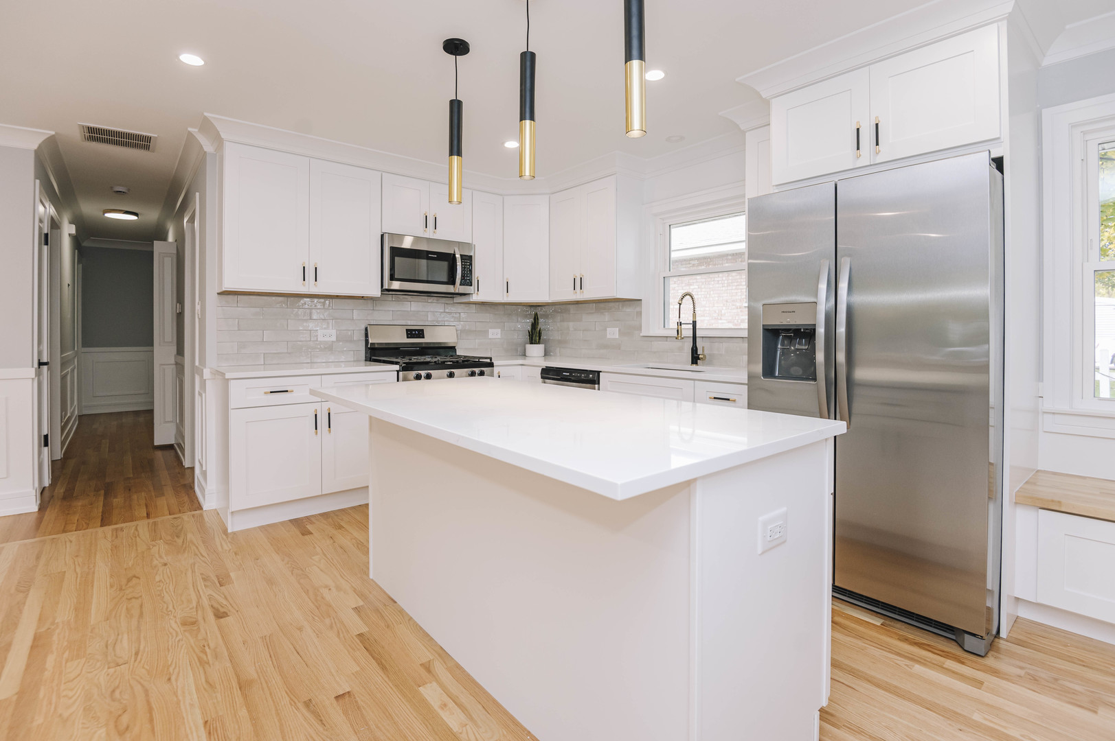 6800 97th Street Oak Lawn, IL 60453 - Photo 7 of 18 a kitchen with stainless steel appliances a refrigerator a sink a stove a microwave and wooden floor