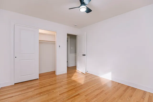 a view of empty room with wooden floor
