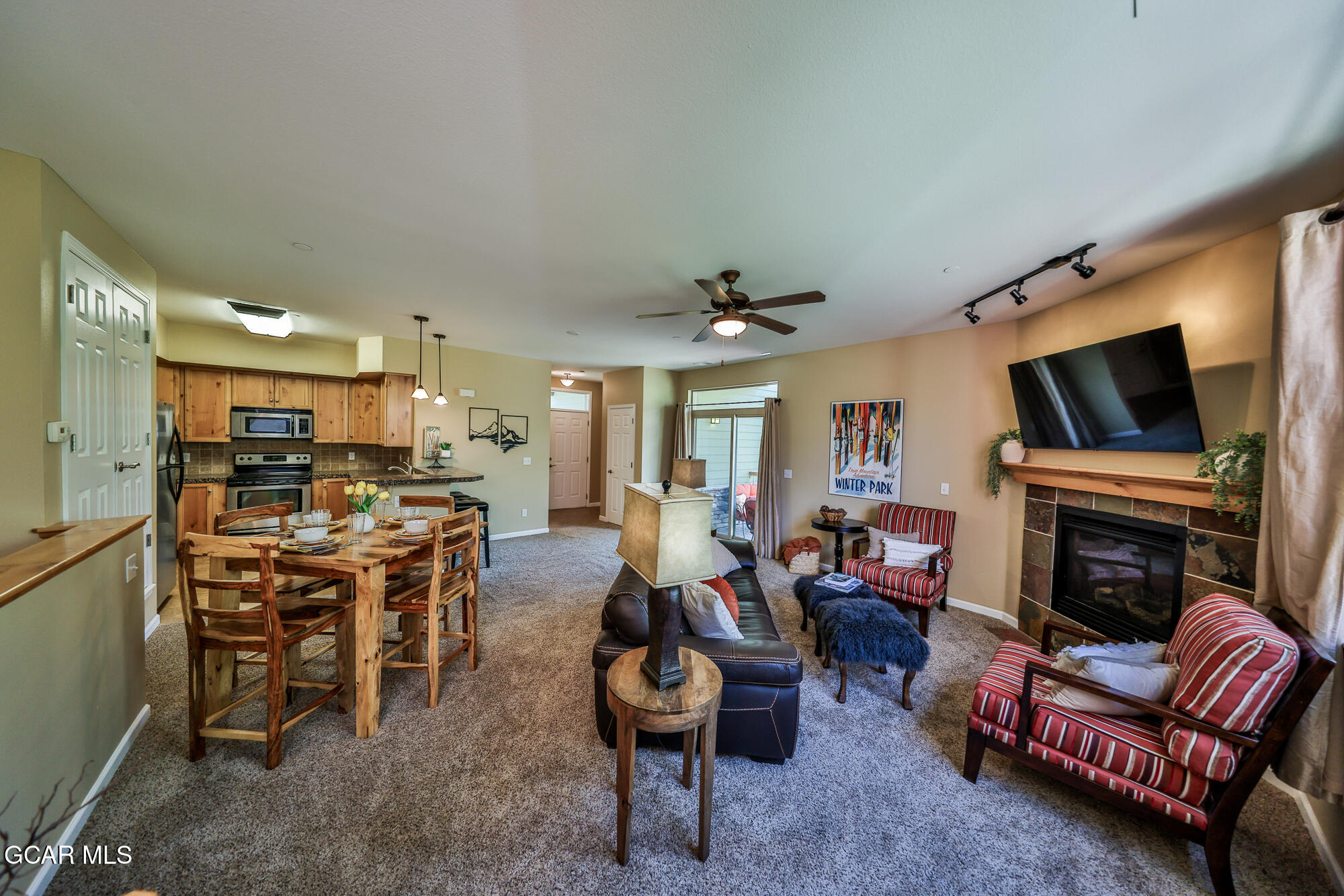 a living room with furniture a fireplace and a flat screen tv