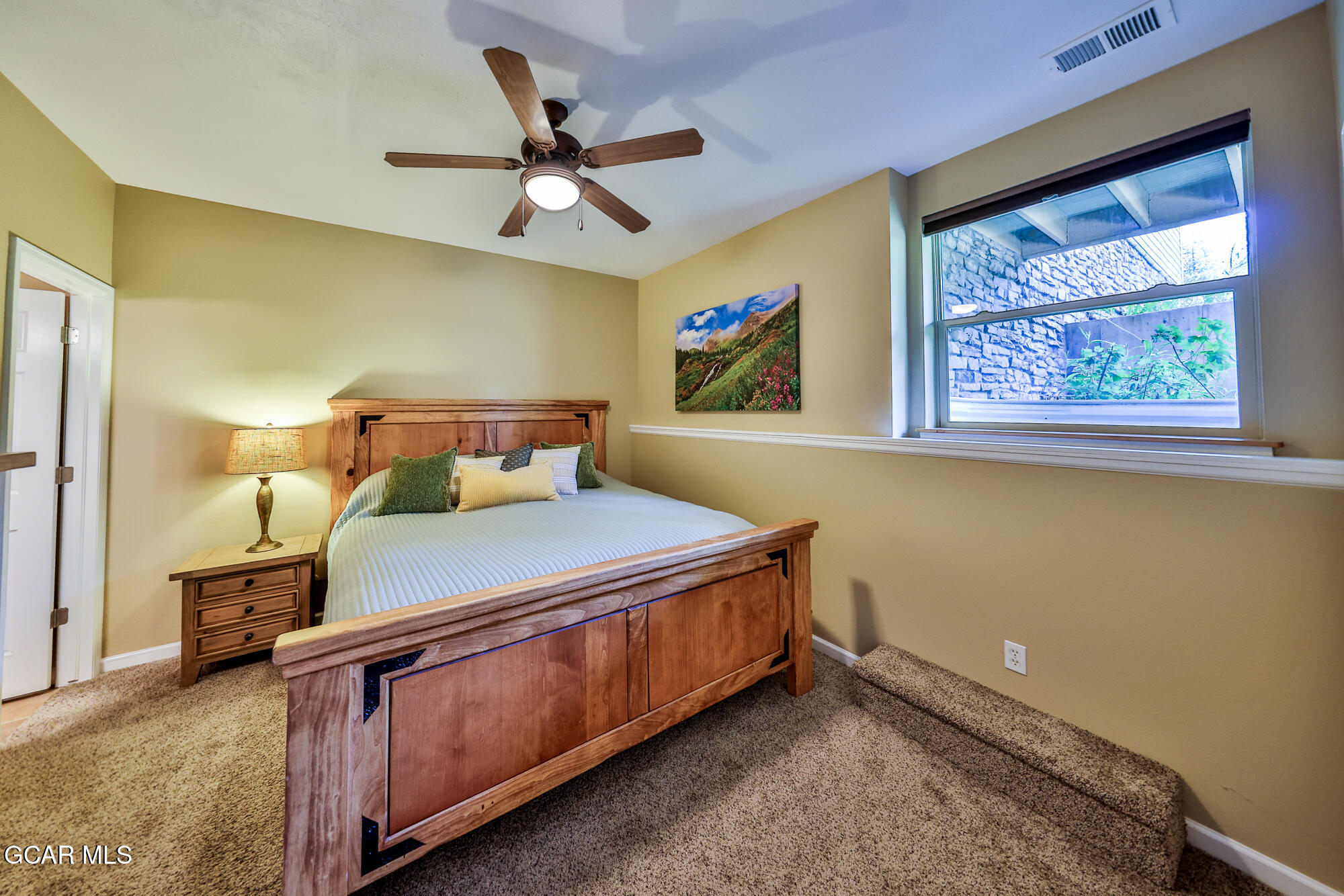 175 Gcr 8340, Unit 1 Fraser, CO 80442 - Photo 14 of 28 a bedroom with a bed and painting on the wall