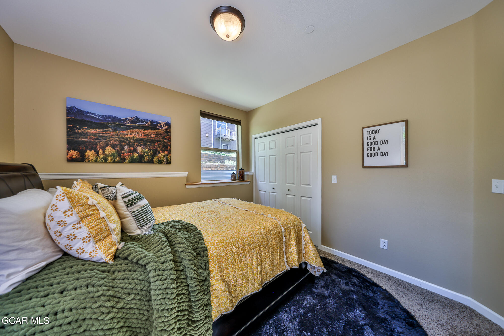 175 Gcr 8340, Unit 1 Fraser, CO 80442 - Photo 21 of 28 a bedroom with a bed and a painting on the wall