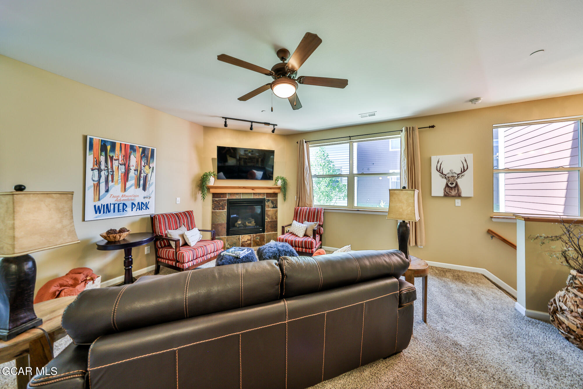 175 Gcr 8340, Unit 1 Fraser, CO 80442 - Photo 3 of 28 a living room with furniture a fireplace and a flat screen tv