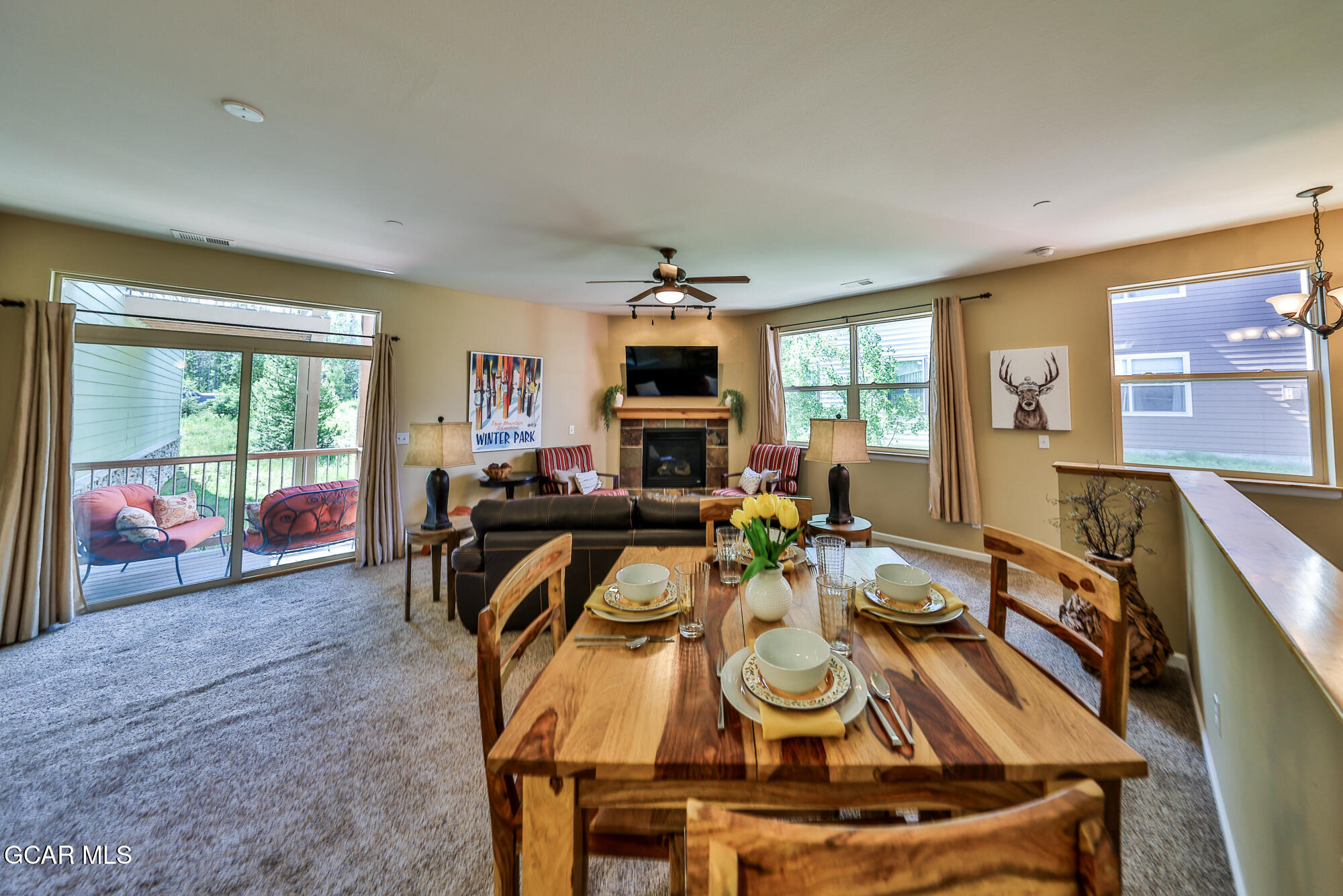 175 Gcr 8340, Unit 1 Fraser, CO 80442 - Photo 7 of 28 a view of a dining room with furniture a chandelier and wooden floor