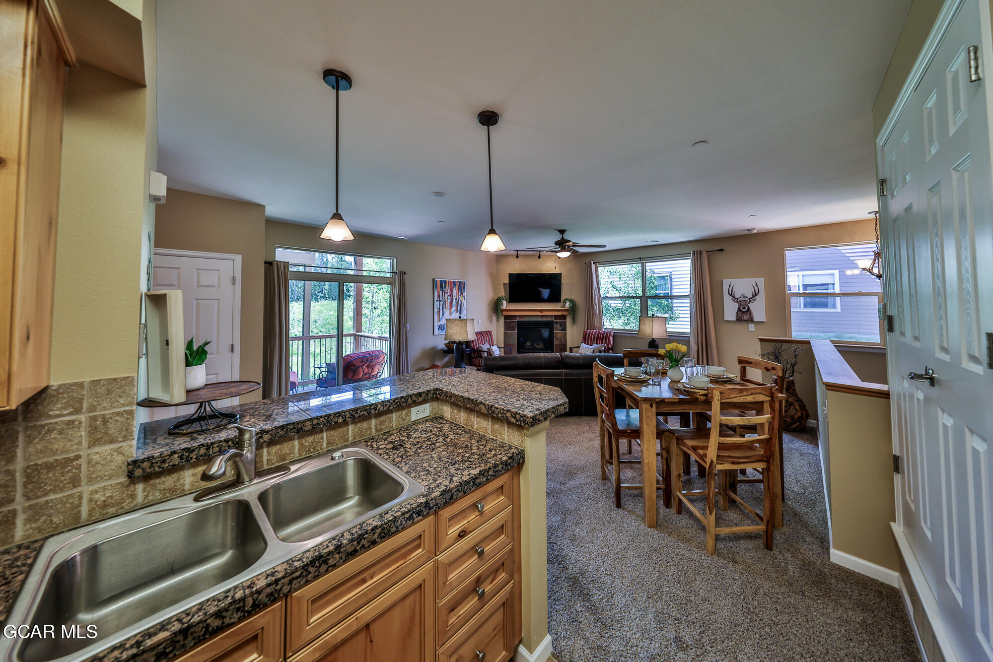 175 Gcr 8340, Unit 1 Fraser, CO 80442 - Photo 9 of 28 a open kitchen with stainless steel appliances granite countertop sink stove and dining table