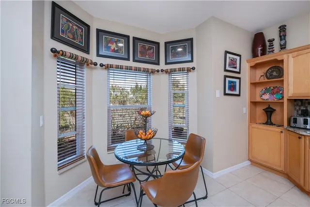 a kitchen with a refrigerator and countertop wooden cabinets