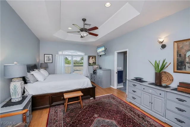 a bedroom with a large bed and a flat screen tv