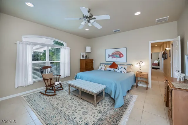 a bathroom with a granite countertop sink mirror and a bathtub