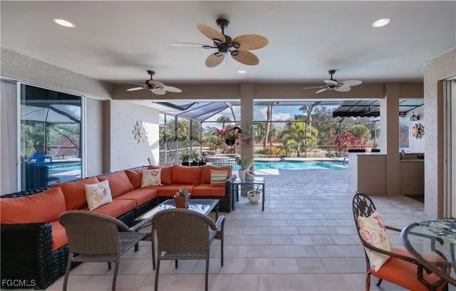 a living room with furniture kitchen view and a chandelier