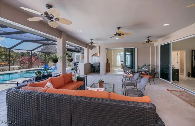 a living room with furniture kitchen view and a chandelier