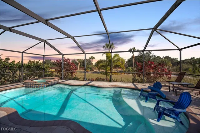 a view of a backyard with table and chairs under an umbrella