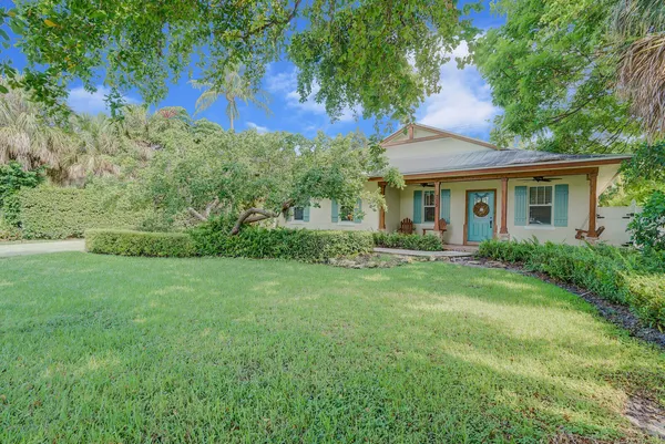 a view of backyard of house with green space