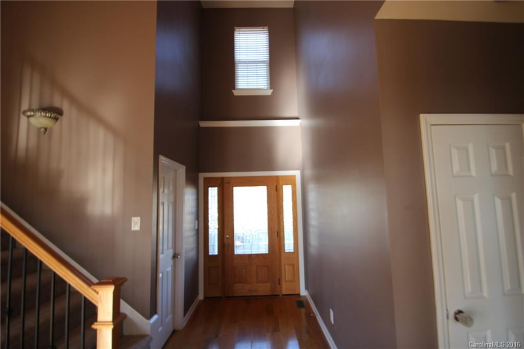 447 Maynard Grayson Road Clover, SC 29710 - Photo 12 of 19 a view of hallway with wooden floor and stairs