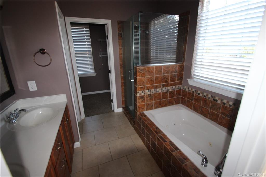 447 Maynard Grayson Road Clover, SC 29710 - Photo 14 of 19 a bathroom with a tub a sink and a large mirror