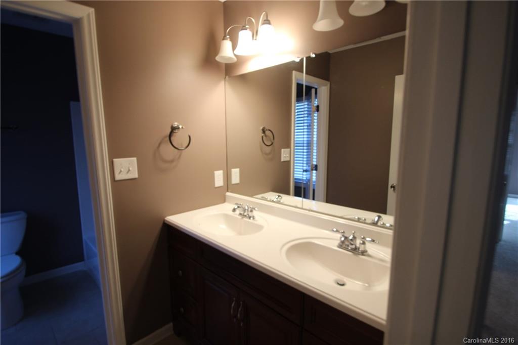 447 Maynard Grayson Road Clover, SC 29710 - Photo 17 of 19 a bathroom with a sink vanity granite and a mirror