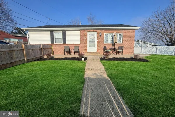 a front view of a house with yard patio and green space