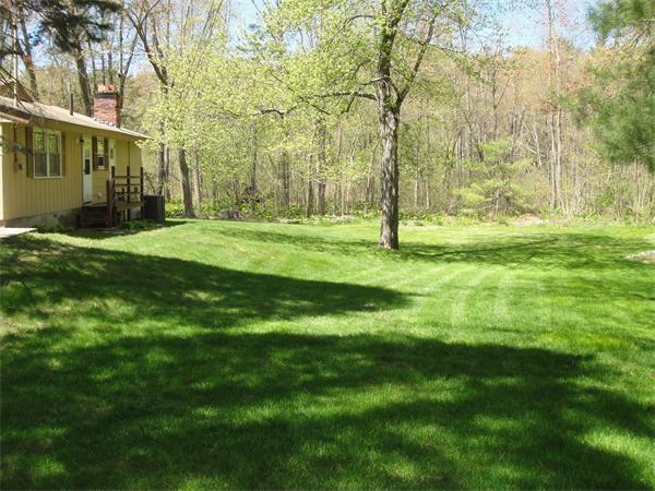 9 Nevada Road Chelmsford, MA 01824 - Photo 4 of 22 a backyard of a house with plants and large trees