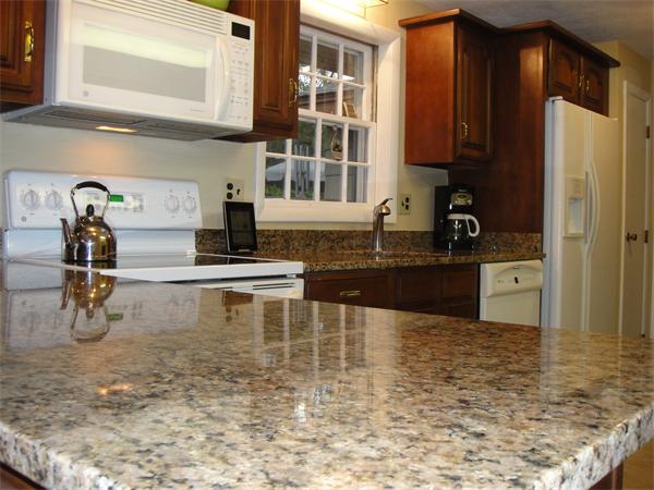 9 Nevada Road Chelmsford, MA 01824 - Photo 8 of 22 a kitchen with granite countertop a stove a sink and a refrigerator
