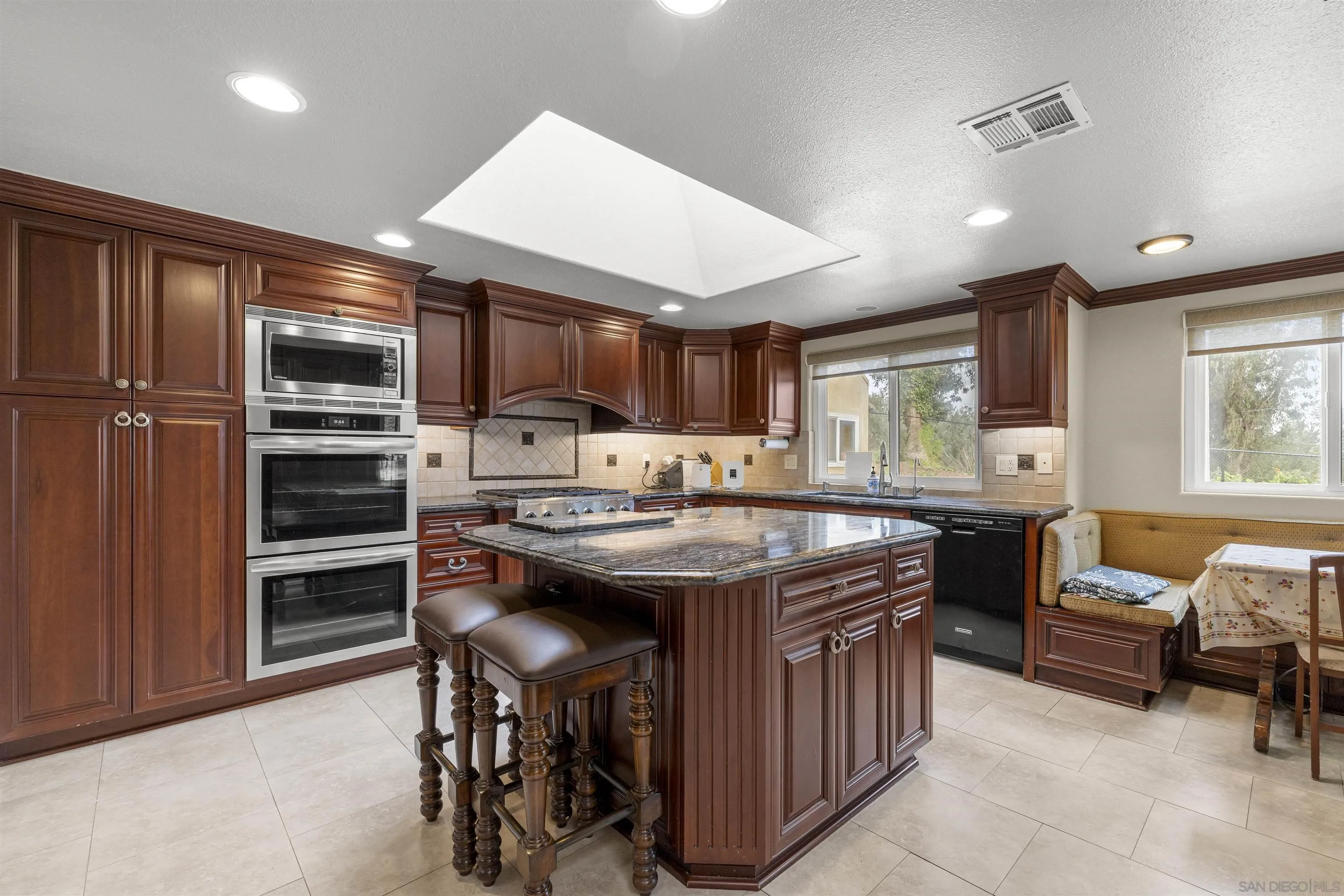 1315 Macadamia Drive Fallbrook, CA 92028 - Photo 12 of 59 a kitchen with stainless steel appliances granite countertop a stove and a refrigerator