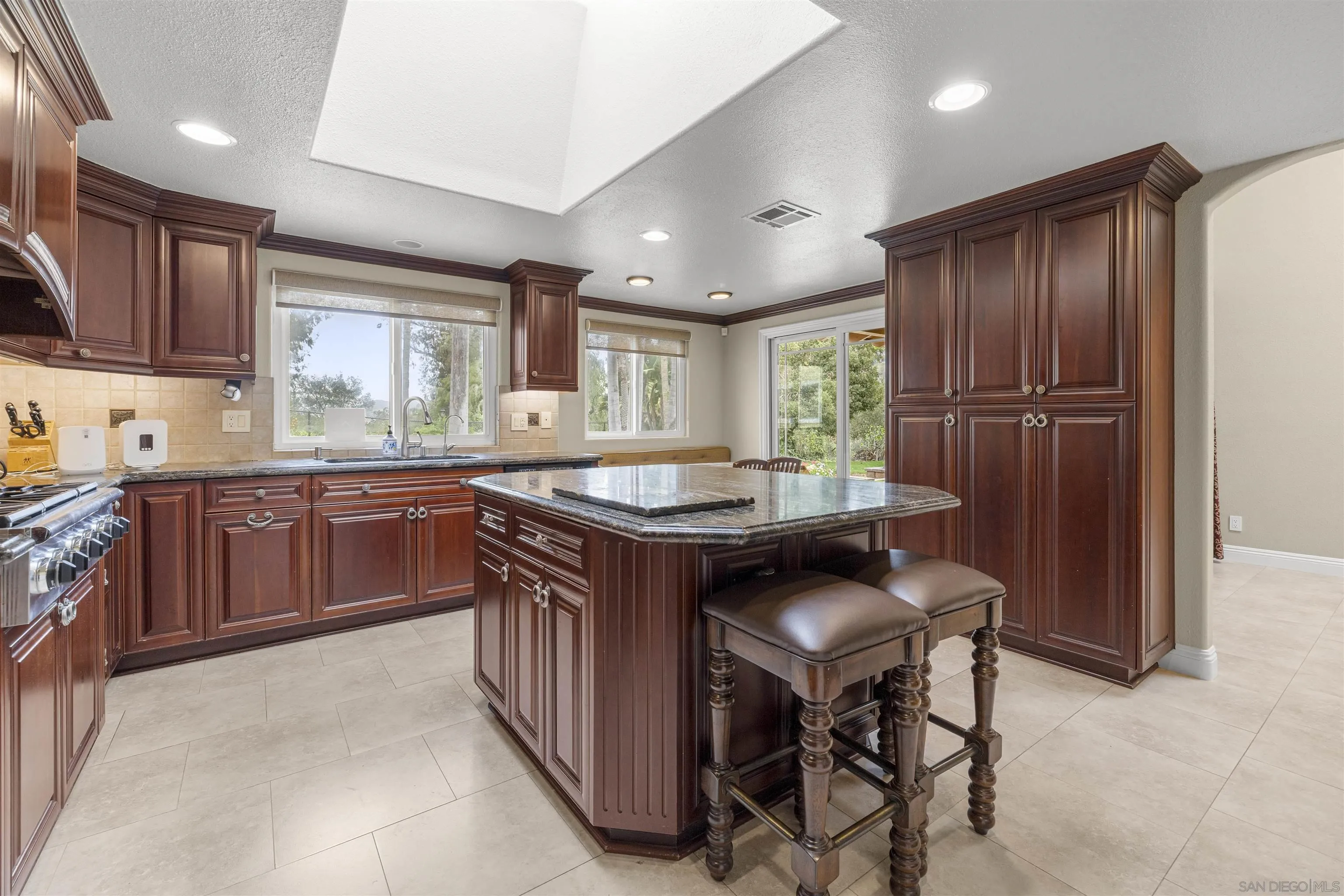 1315 Macadamia Drive Fallbrook, CA 92028 - Photo 15 of 59 a kitchen with a stove a sink and a refrigerator