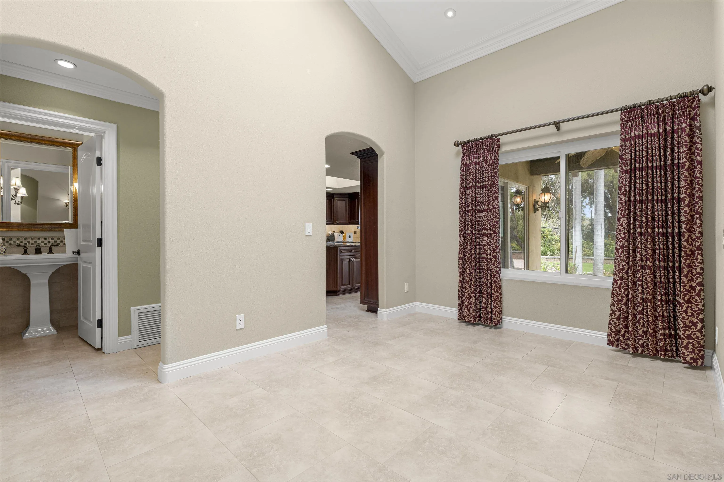 1315 Macadamia Drive Fallbrook, CA 92028 - Photo 18 of 59 a view of an empty room with a fireplace and a window