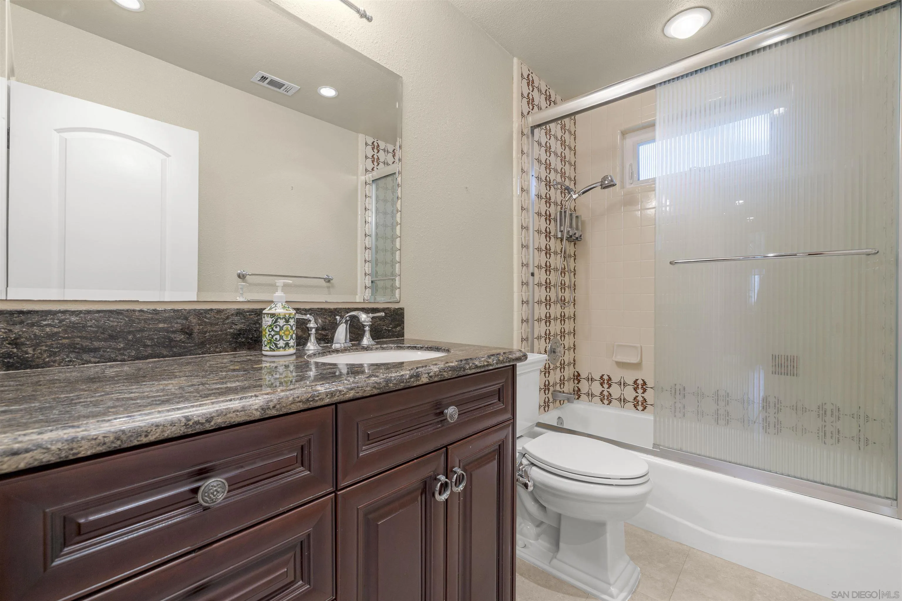 1315 Macadamia Drive Fallbrook, CA 92028 - Photo 23 of 59 a bathroom with a granite countertop sink a toilet and shower