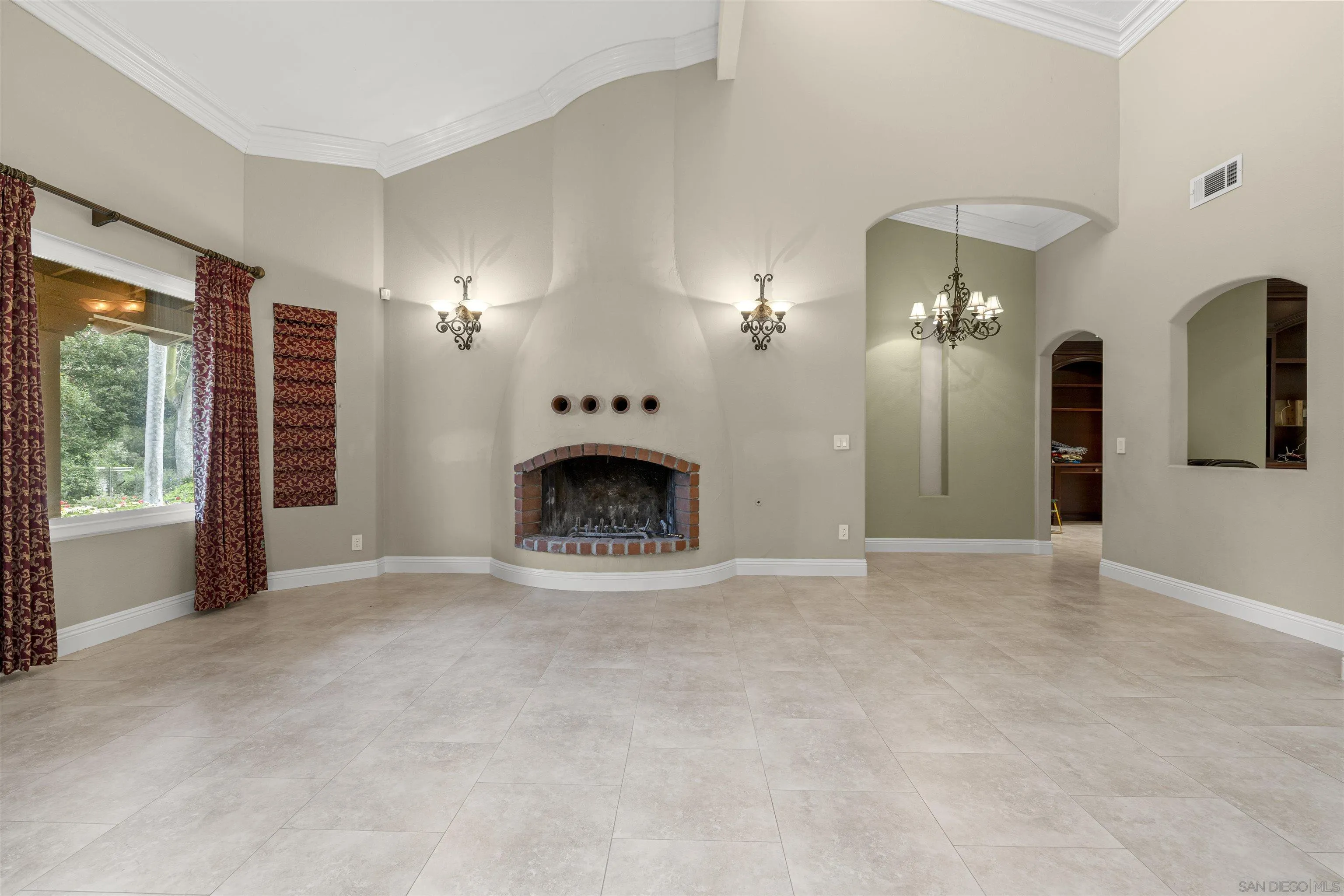 1315 Macadamia Drive Fallbrook, CA 92028 - Photo 38 of 59 an empty room with chandelier fan and windows