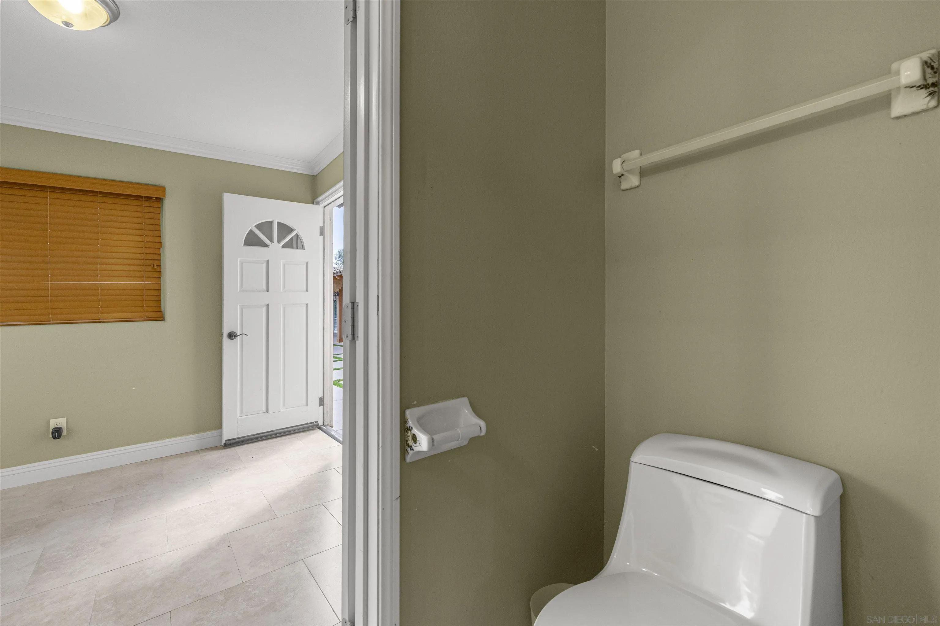 1315 Macadamia Drive Fallbrook, CA 92028 - Photo 43 of 59 a white toilet sitting next to a bathroom sink