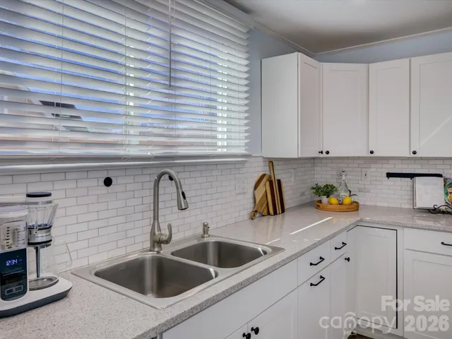 a kitchen with sink and cabinets