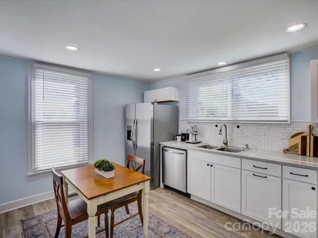 a kitchen with stainless steel appliances granite countertop a sink refrigerator and microwave