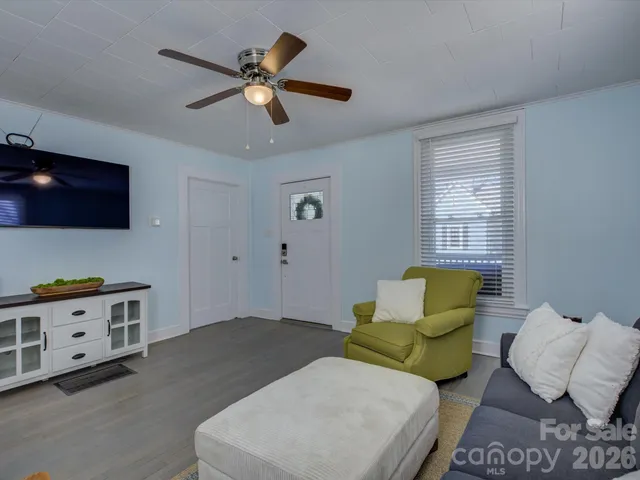 a living room with furniture and a flat screen tv