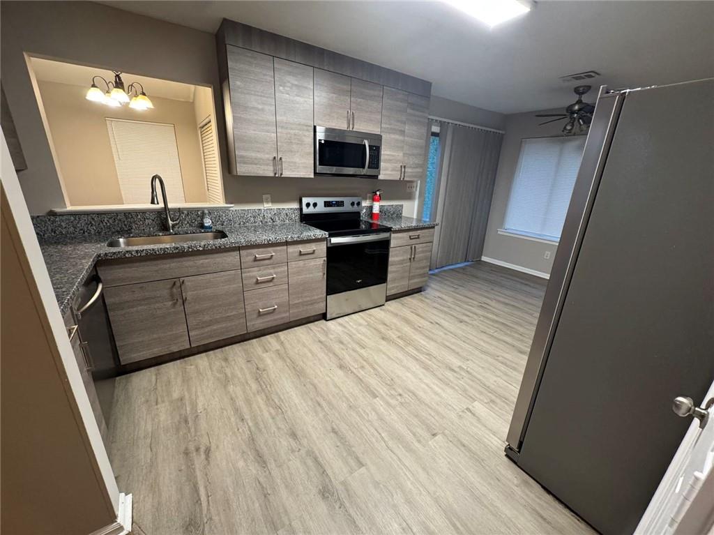 316 Ridgestone Drive Warner Robins, GA 31088 - Photo 3 of 21 a large kitchen with a sink a microwave and wooden floor