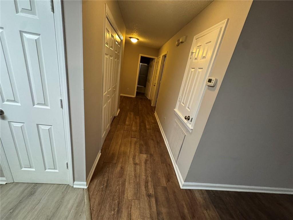 316 Ridgestone Drive Warner Robins, GA 31088 - Photo 6 of 21 a view of a hallway with wooden floor and staircase