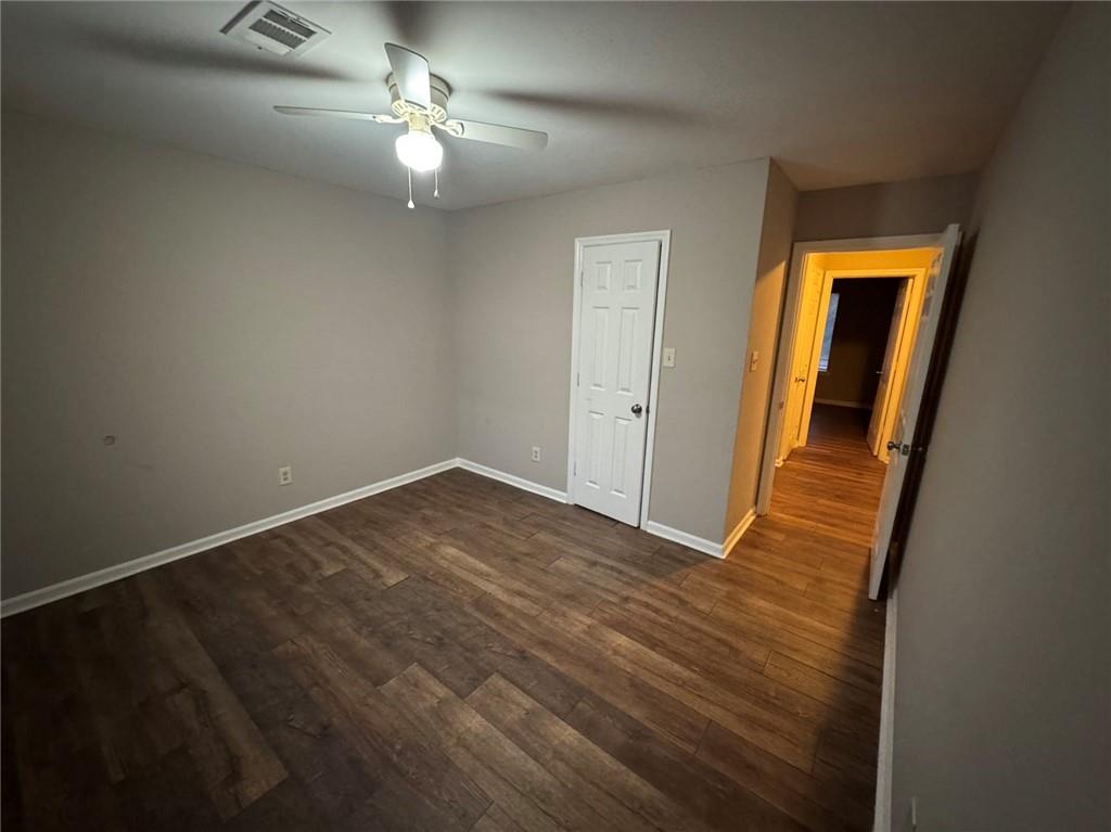 316 Ridgestone Drive Warner Robins, GA 31088 - Photo 10 of 21 a view of an empty room with wooden floor and a ceiling fan