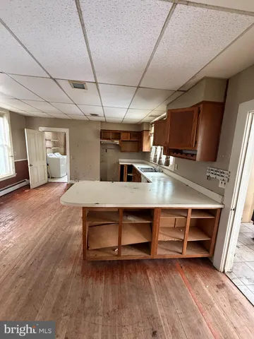 a view of a livingroom with a chandelier fan and windows